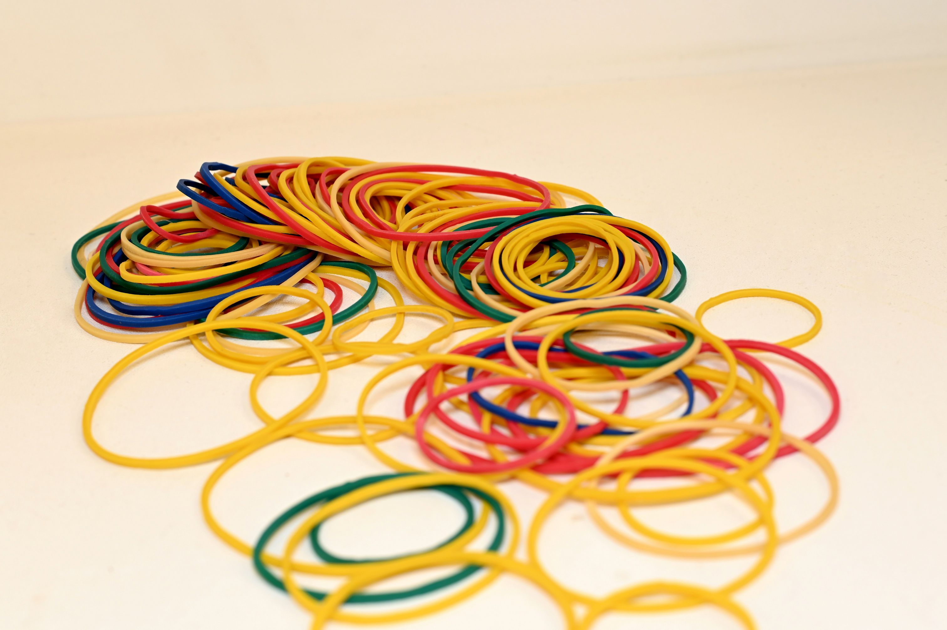 A photograph of several red, blue, yellow, and green rubber bands